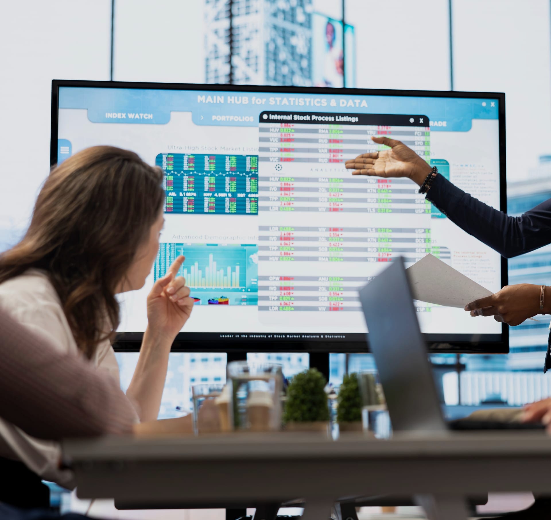 Enterprise data solutions — team reviewing statistics dashboard.
